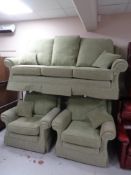 A 3 piece lounge suite upholstered in Green floral fabric