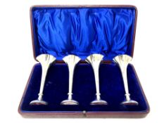 A cased set of four loaded silver flower vases, Sheffield 1907, height 12cm.