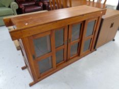 A hardwood bookcase with sliding glass doors