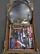 A box containing a large quantity of plated flatware and boxed crested spoons together with silver