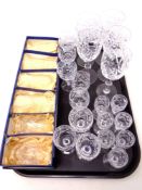 A tray of boxed and unboxed cut glass champagne glasses,