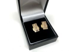 A pair of 9ct gold tie pins