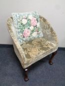 A 20th century tub chair on mahogany claw and ball legs,