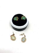 A pair of cabochon jade earrings, stamped 18K,