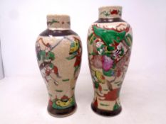 Two Japanese crackle glazed vases, depicting Samurai in battle, character marks to base,