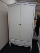 A contemporary arch topped double door wardrobe fitted with draw on raised legs (white)