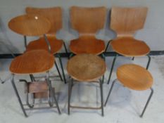 A set of three mid 20th century bent plywood chairs on metal legs together with two further similar