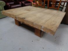 A large square pine coffee table