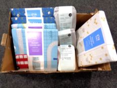 A basket of Dunelm single and double duvet cover sets together with Next Cool Touch fitted sheet
