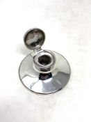 A silver inkwell with glass liner, Birmingham marks, diameter 8.5cm.