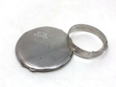 A silver compact together with a silver bangle