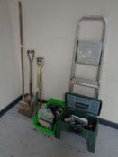 A garden storage stool and box containing power tools, hand tools,