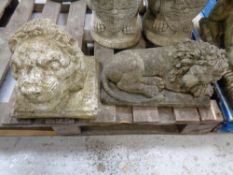 A concrete figure of a recumbent lion together with a further lion wall mask