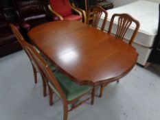 A reproduction extending dining table and set of 4 chairs