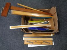 A box of surveyor's rulers and measures