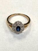 A 9ct gold diamond and sapphire cluster ring, millgrain set 0.