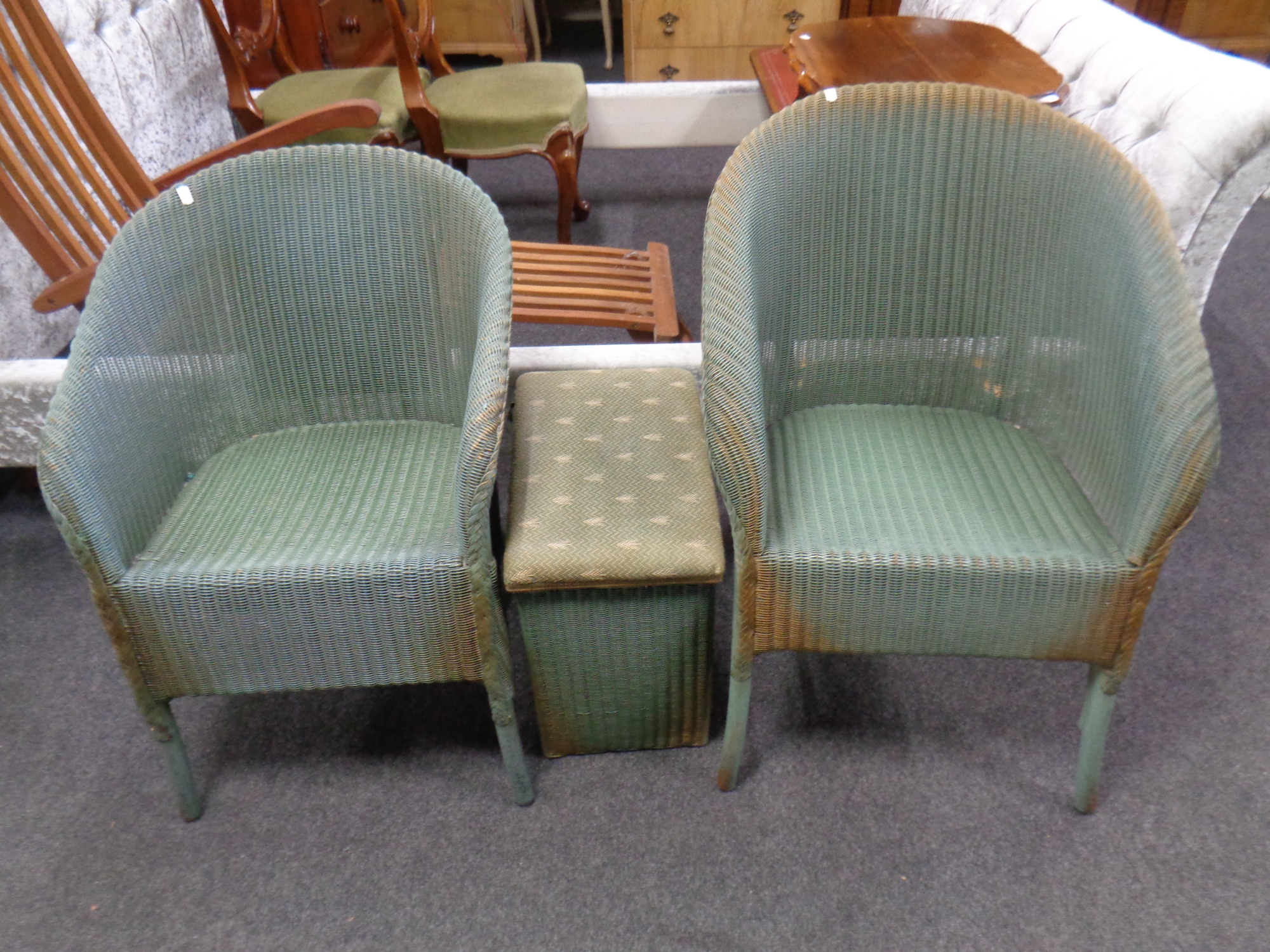 Two green loom chairs together with a storage box