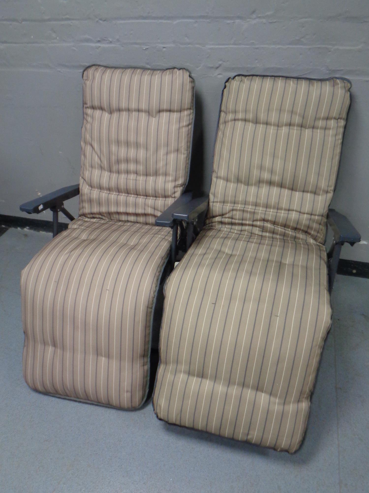 A pair of folding garden armchairs