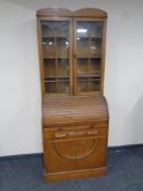A 1930's barrel fronted bureau bookcase