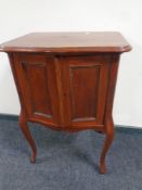 A double door gramophone cabinet on raised legs