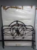 A cast iron 5' bed frame with Staples interior