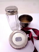 A silver photograph frame, child's vintage egg cup, dressing table bottle.