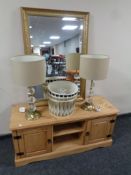 A contemporary pine entertainment stand together with a gilt framed mirror,