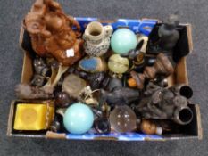 A box carved wooden tourist pieces, glass ball and dice,