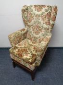 A 20th century wing backed fireside chair