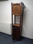 A 20th century oak cupboard fitted with clock and pendulum