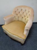 A 20th century bedroom armchair in gold buttoned fabric