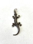 A silver lizard pendant.