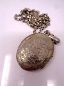 A large vintage silver locket on chain.