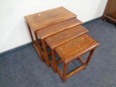 A nest of three mahogany Eastern style tables with brass inlay