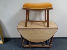 An Edwardian oak gate leg table together with dressing table stool
