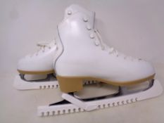 A pair of white leather Risport skates