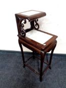 A 20th century Chinese style side table with raised shelf and two marble inset panels