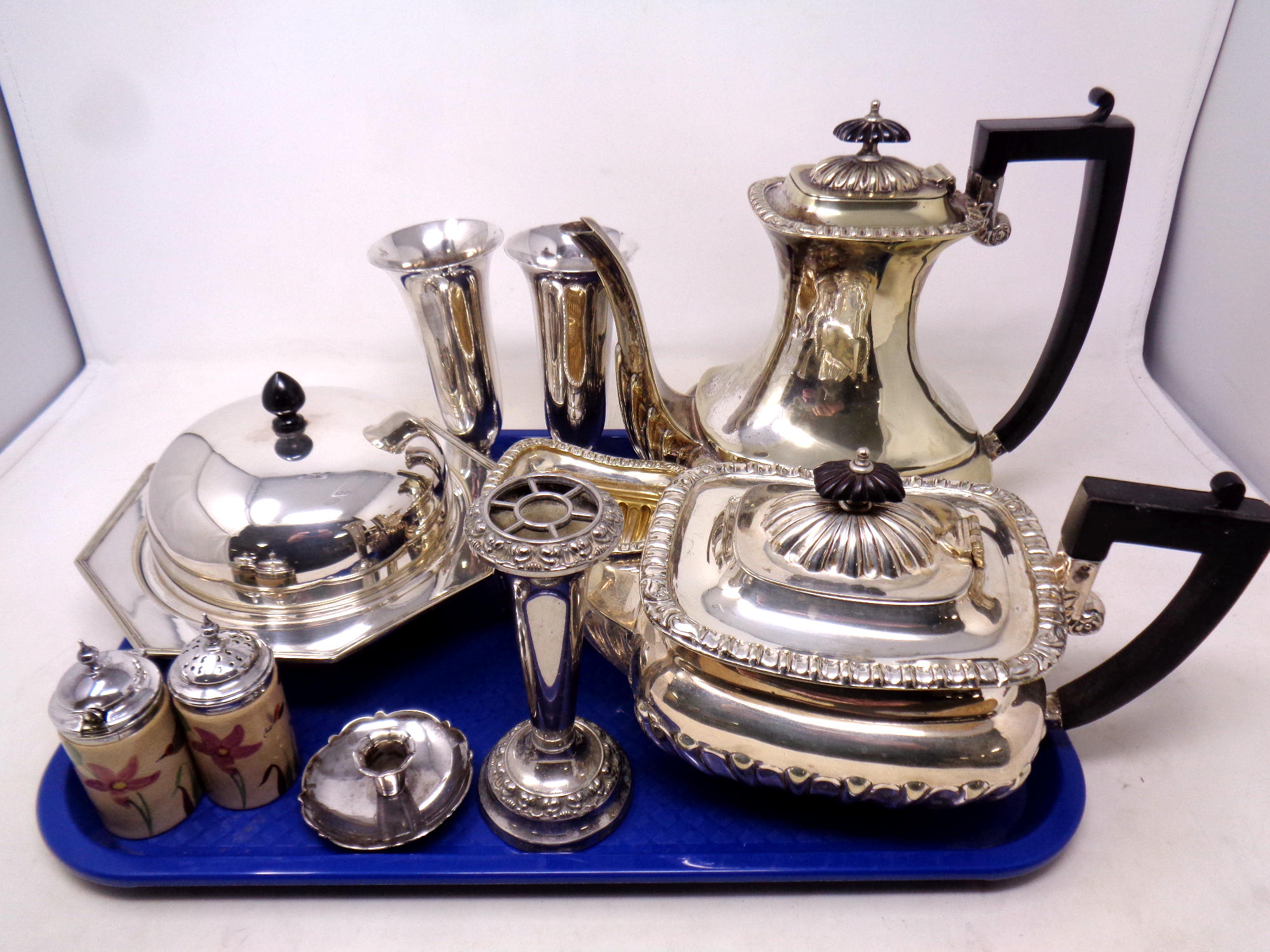 A tray of silver plated items including three piece tea set, muffin dish,