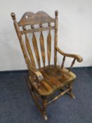 A beechwood high backed rocking chair