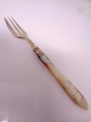 A silver and mother of pearl pickle fork.