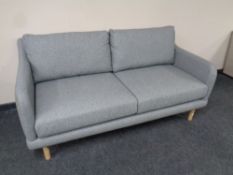 A contemporary two seater settee in grey fabric