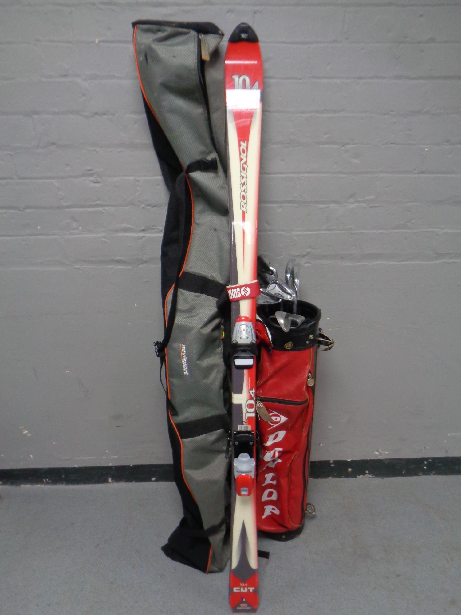 A pair of Rossignol skis in bag together with a golf bag containing Mizuno irons