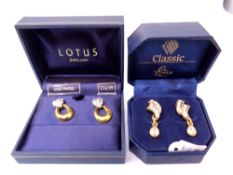 2 cased pairs of Lotus earrings.