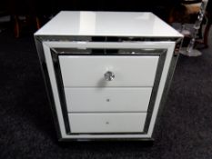 A contemporary Cimc home all glass three drawer bedside chest