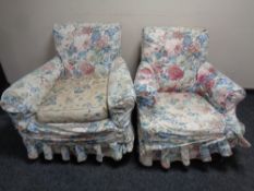A pair of Edwardian armchairs on mahogany legs with loose floral covers