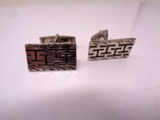 A pair of silver cuff links.