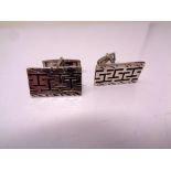 A pair of silver cuff links.