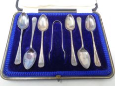 A set of six silver teaspoons with matching sugar tongs