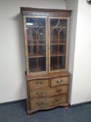 A 19th century mahogany double door bookcase on four drawer base