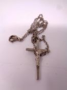 A silver crucifix on chain.